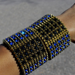 A High Polished Gold Expandable Bracelet featuring Blue and Black Stone Design. 